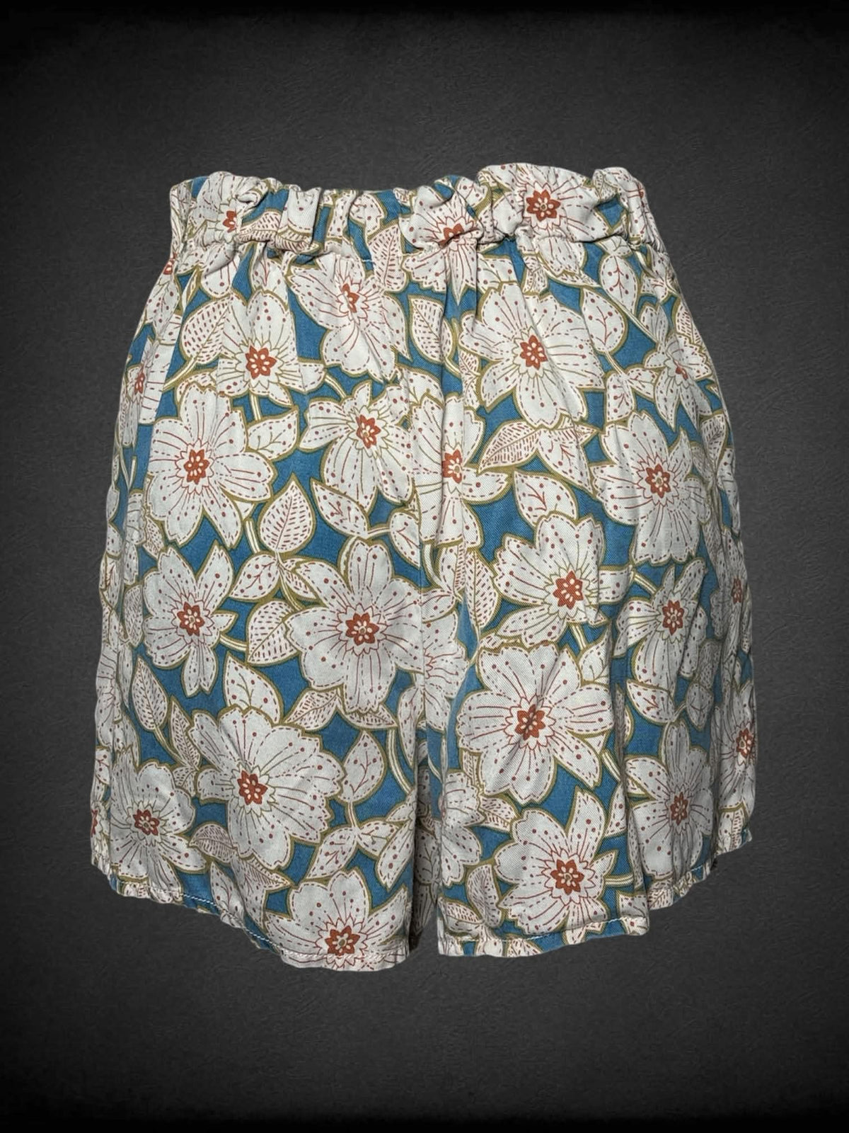 S Anthropologie blue wrap-around shorts with floral design, and zipper on side