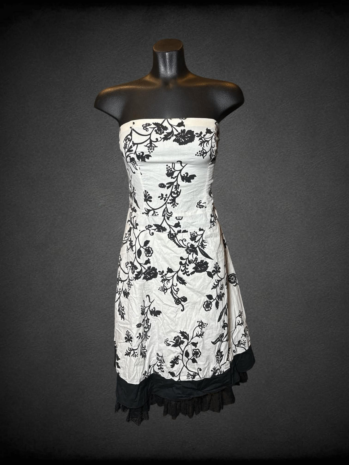 S Twenty One white strapless dress with black floral pattern, lace hemline, and zipper on back