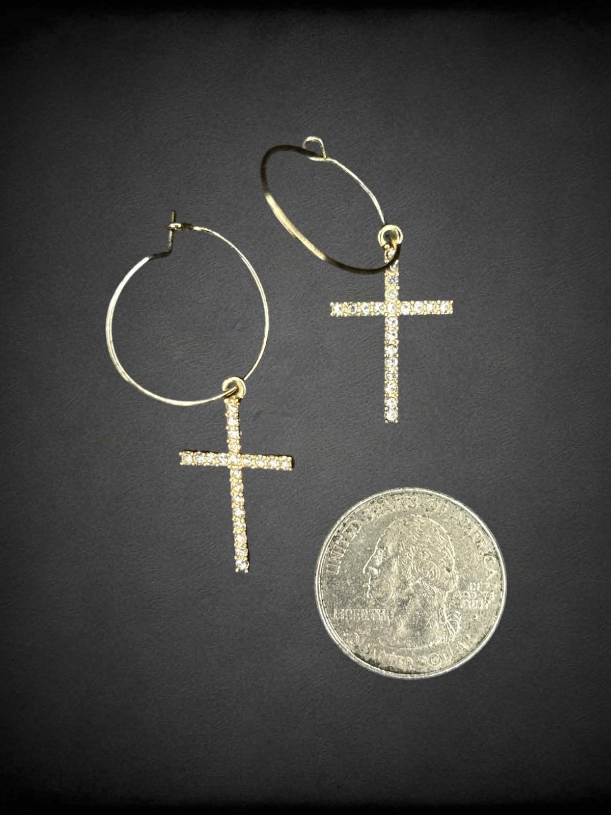 Gold hoop earrings with bejeweled cross charms