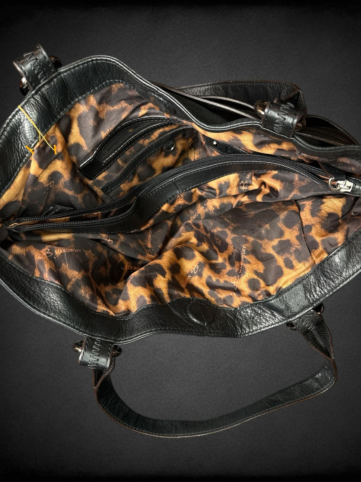 B. Makowsky designer black leather shoulder bag with zipper pockets and magnetic snap button