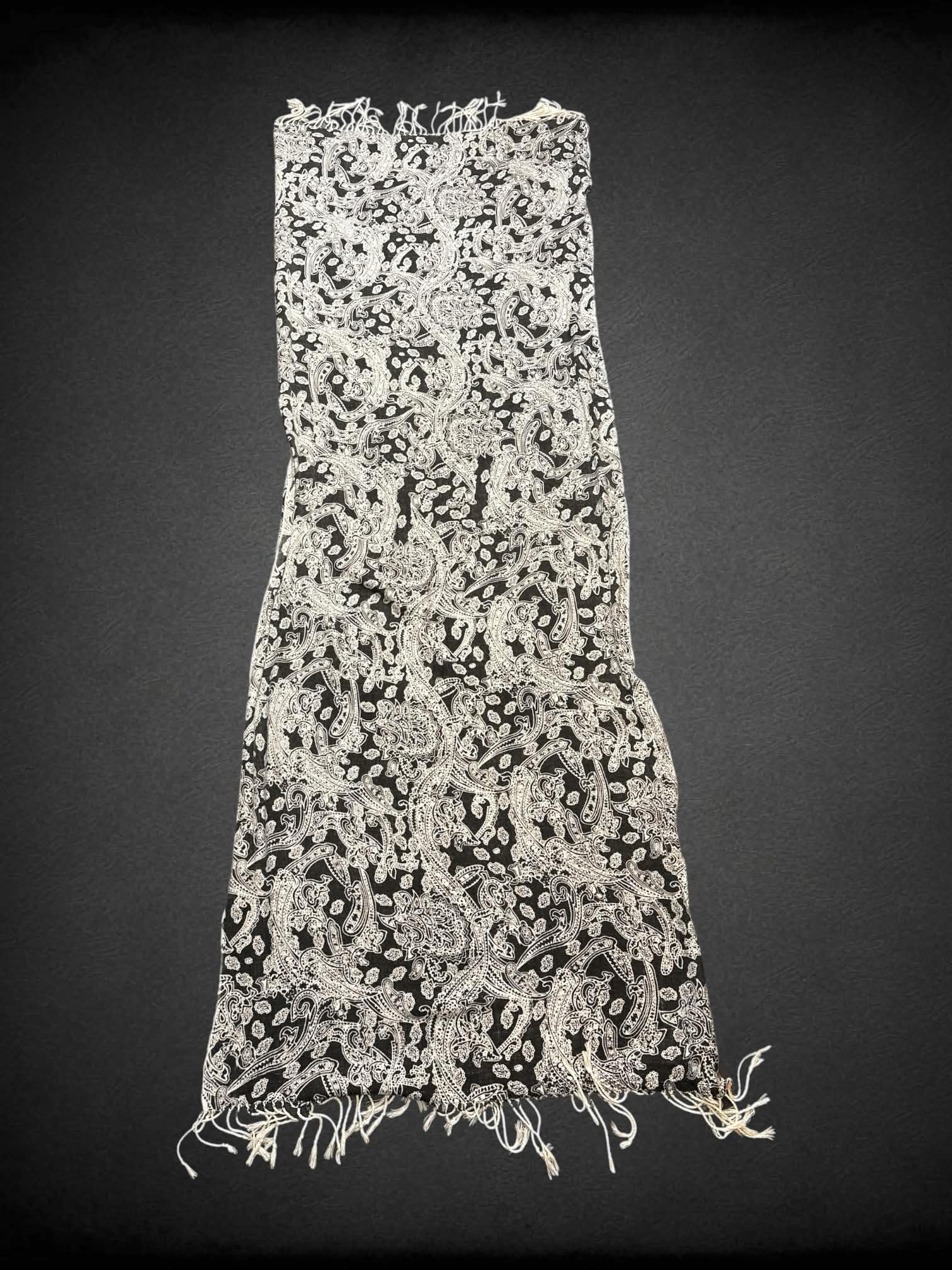 28 x 70 inch black scarf/shawl with white paisley design, and tassels