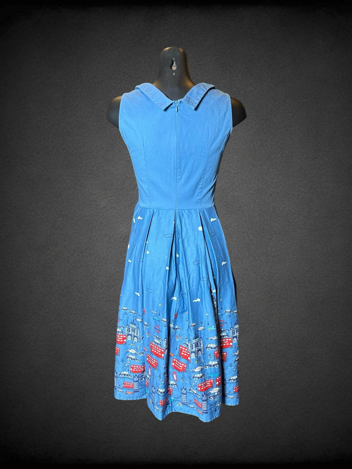 M blue dress with pleated skirt, city London pattern, and zipper on back