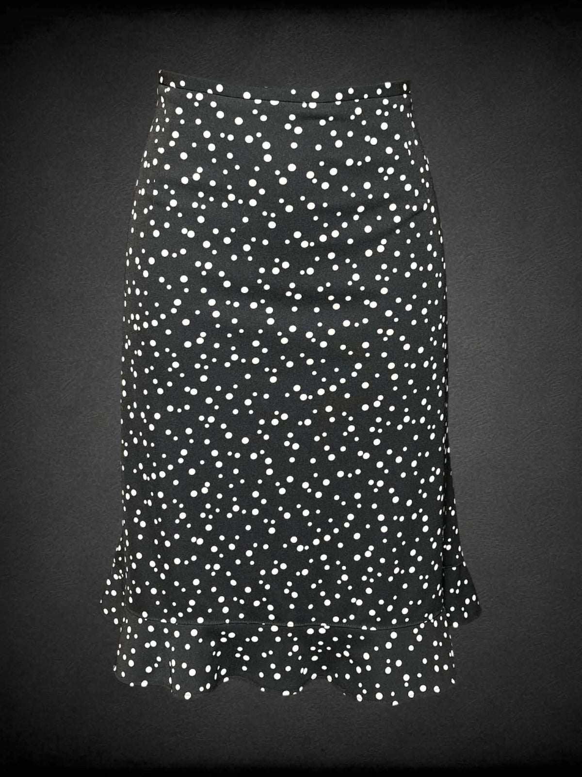 M Requirements vintage black skirt with white spotted pattern, ruffled hemline, and zipper on side