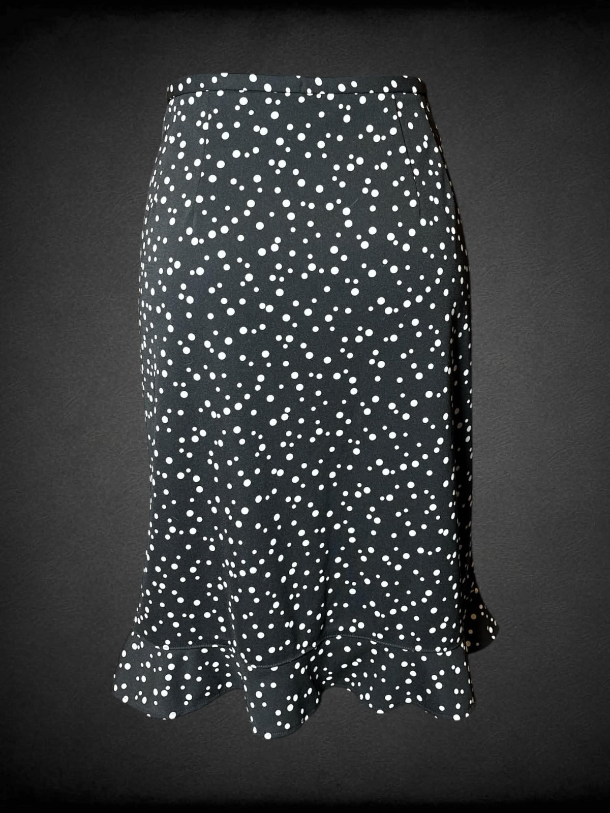 M Requirements vintage black skirt with white spotted pattern, ruffled hemline, and zipper on side