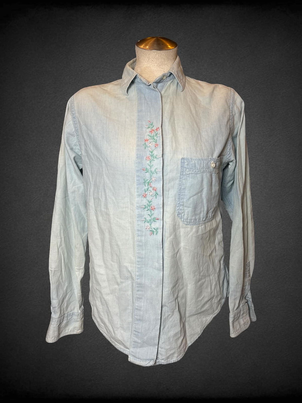 L L. L. Bean blue denim button-up shirt with embroidered floral design on front, and pocket on front