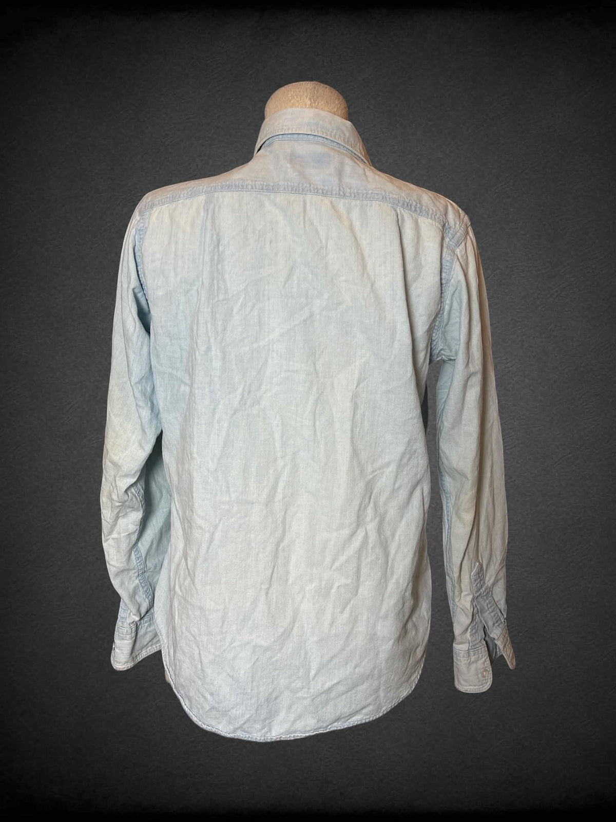 L L. L. Bean blue denim button-up shirt with embroidered floral design on front, and pocket on front