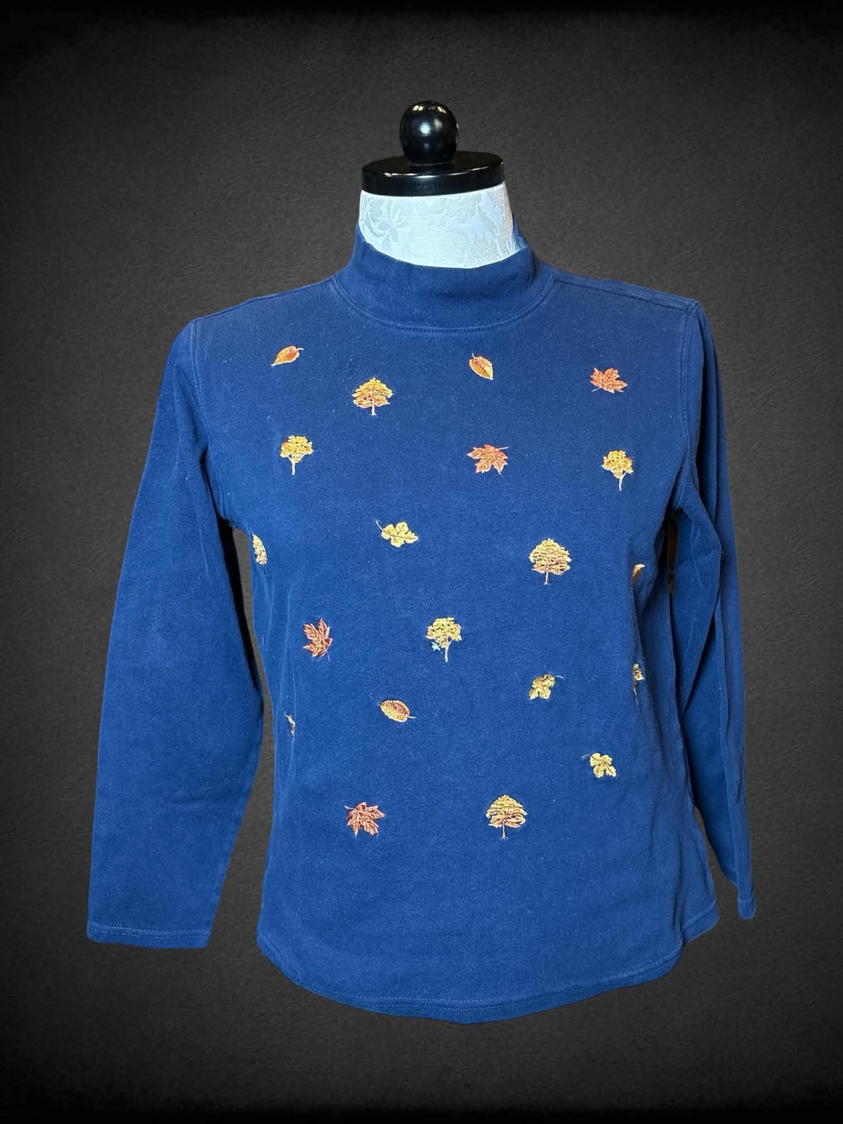 0X Studio Works navy long-sleeve turtleneck shirt with embroidered autumn tree design on front