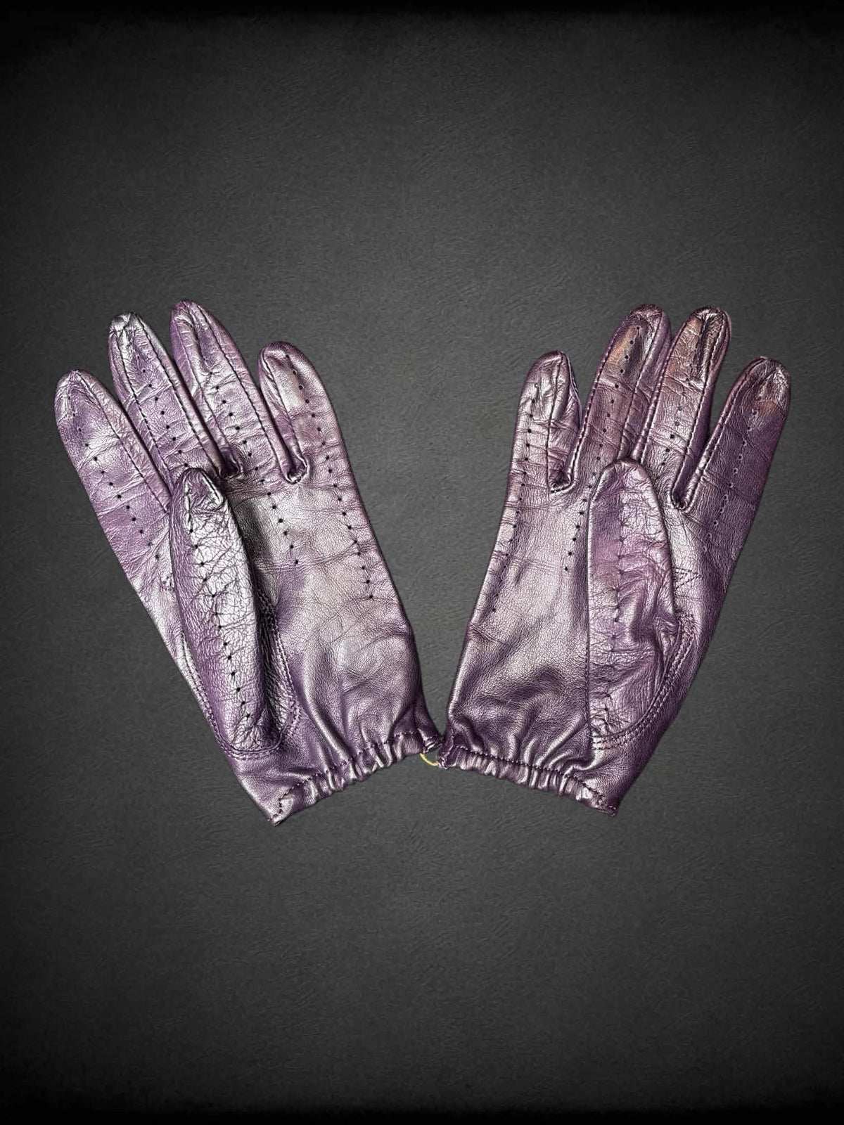 Gravelly Orsini purple leather gloves with cutout design on nuckles, and snap button