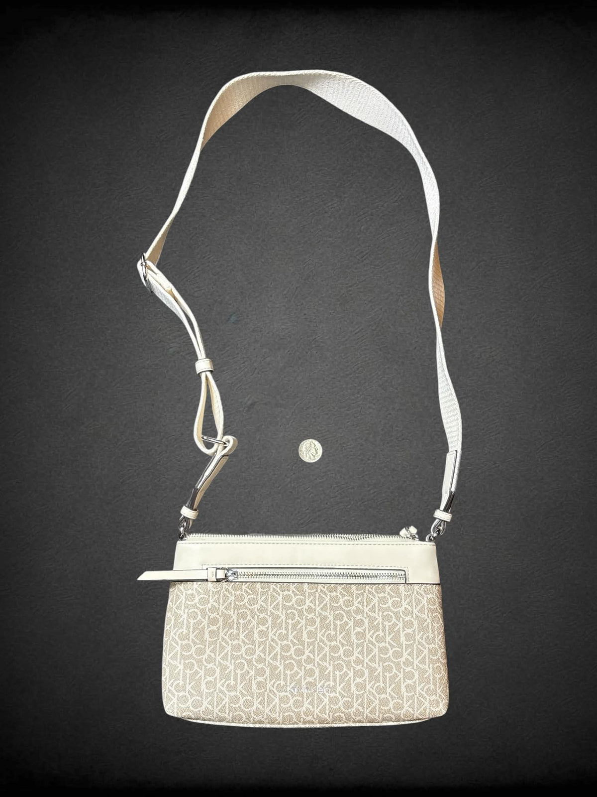 Calvin Klein beige shoulder bag with zipper pockets, and adjustable strap