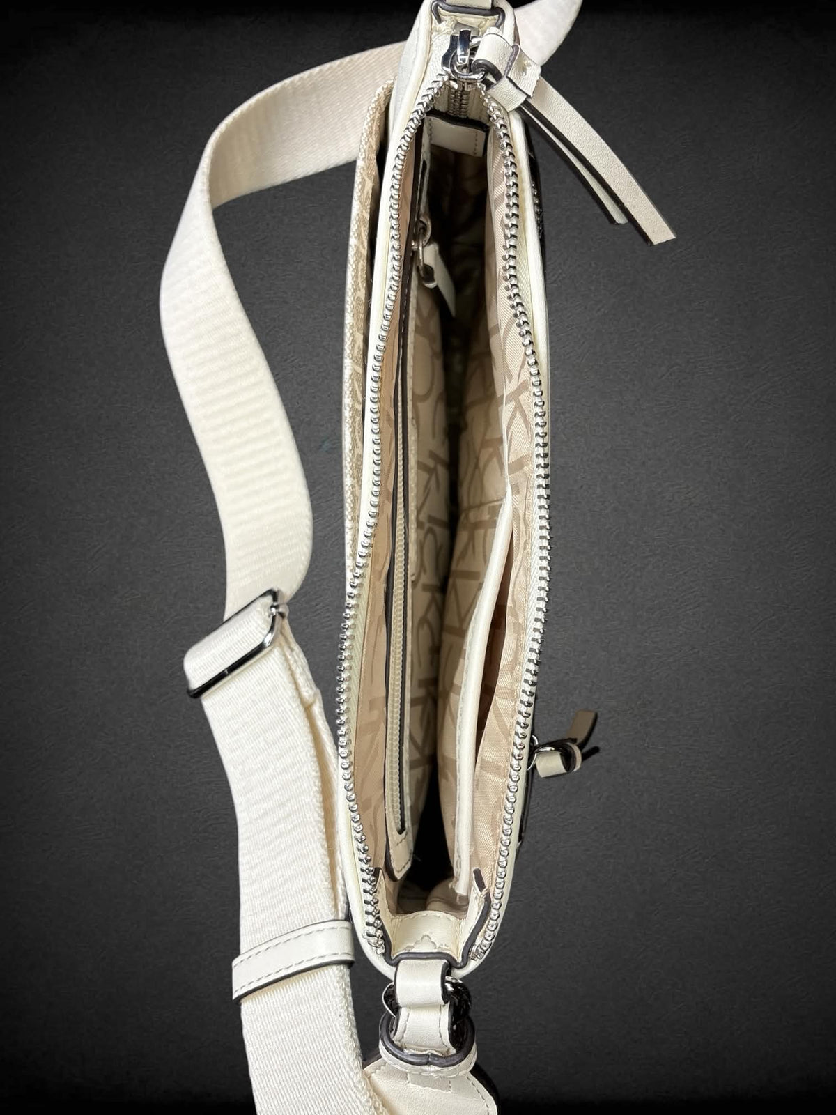 Calvin Klein beige shoulder bag with zipper pockets, and adjustable strap