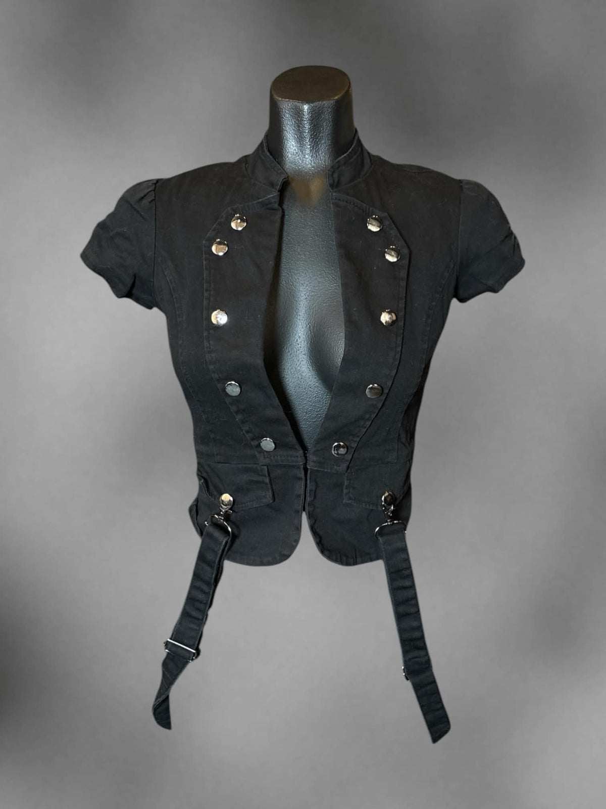 S black fitted blazer top with clasp on front, decorative buttons, and loop straps
