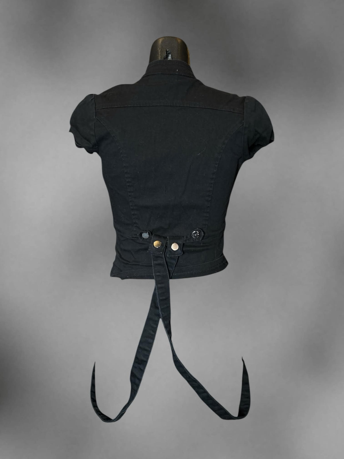 S black fitted blazer top with clasp on front, decorative buttons, and loop straps