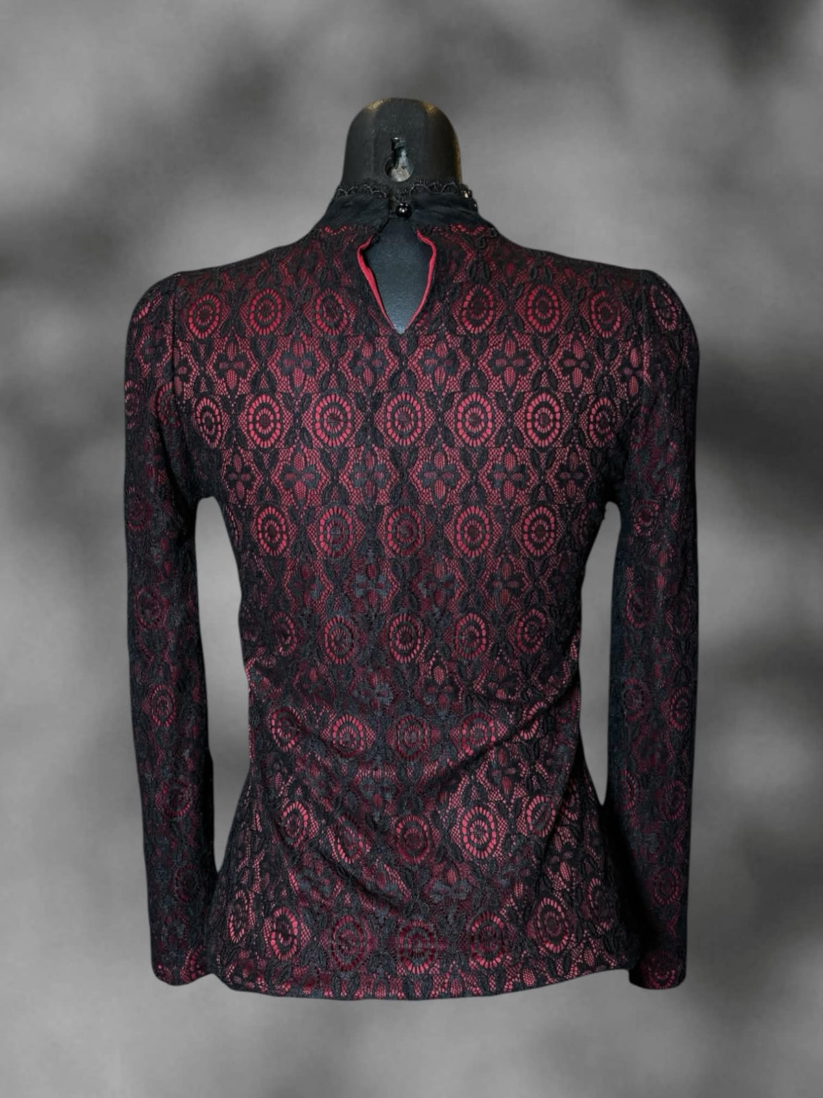 M Feife Dress red long-sleeve blouse with black lace design, ruffle collar, and button on back