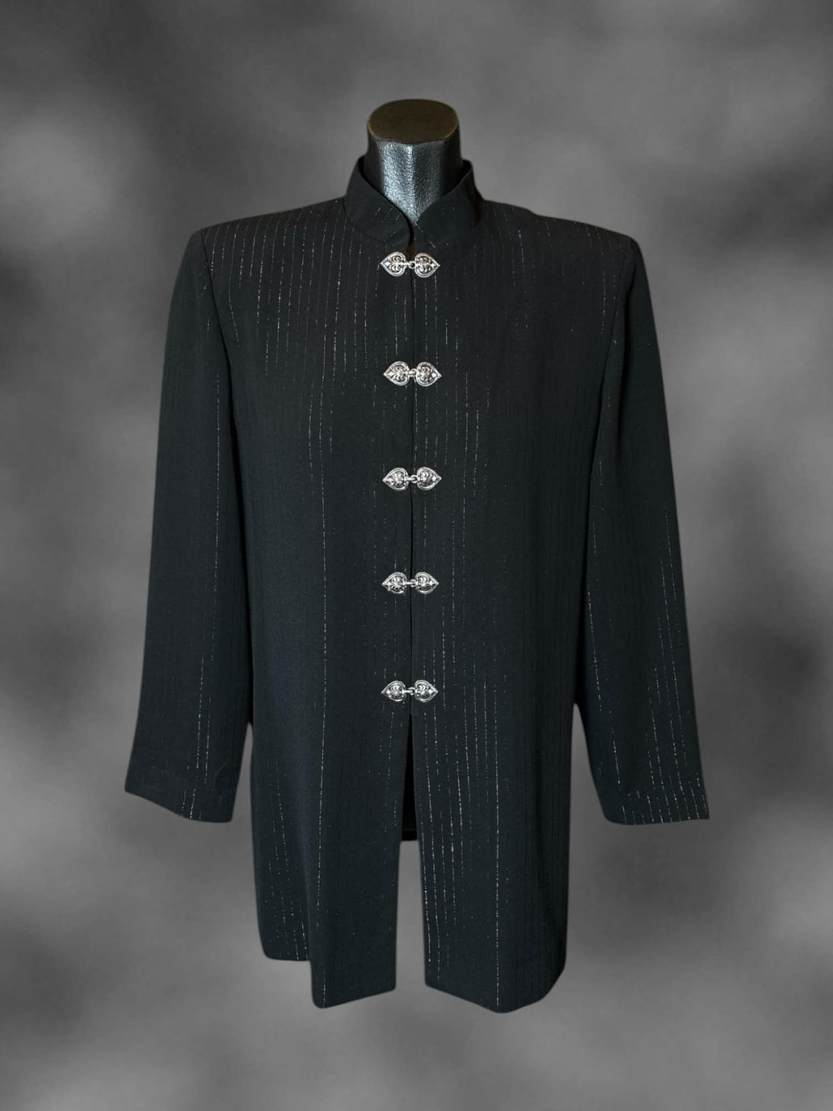 M R&M Richards vintage black coat with striped design, metallic clasps on front, and padded shoulders