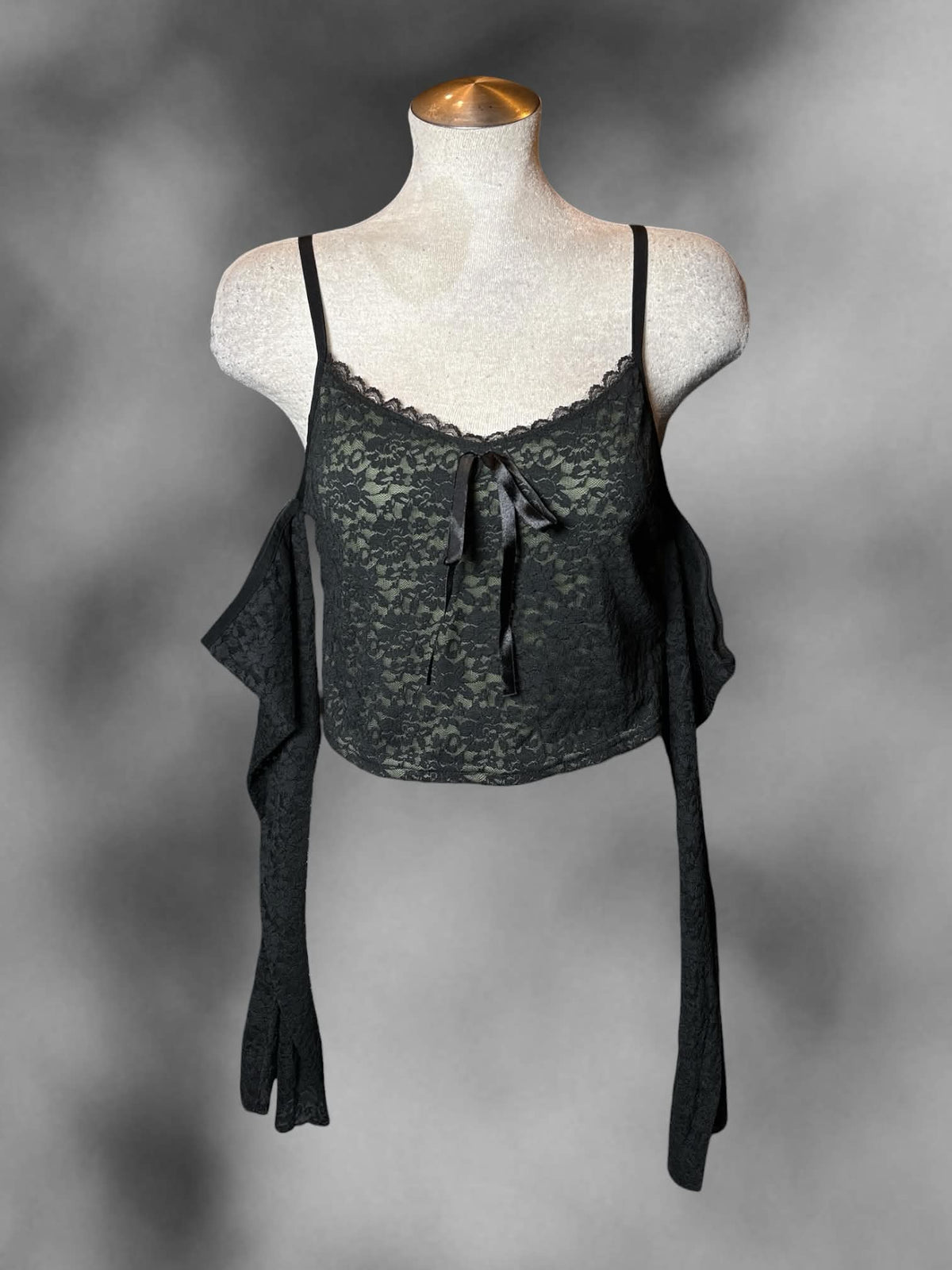L Thorn & Fable green cropped off-the-shoulder top with black lace detailing, and adjustable straps