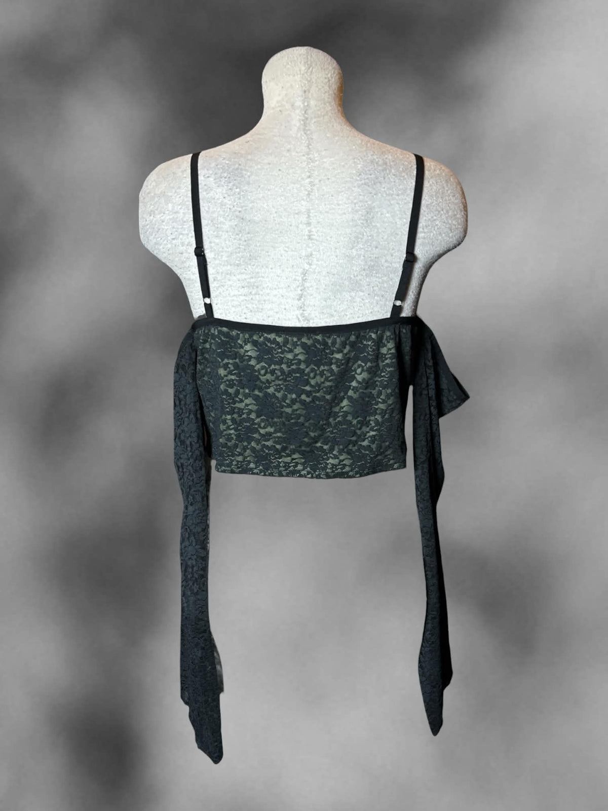 L Thorn & Fable green cropped off-the-shoulder top with black lace detailing, and adjustable straps
