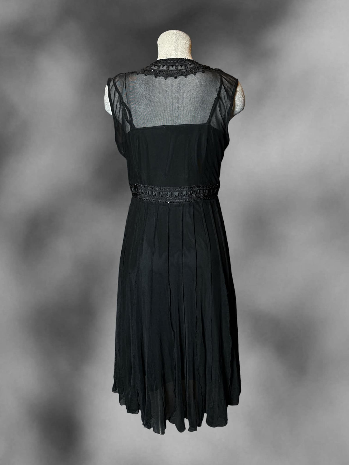 L ECI black two-piece dress with beaded embroidered design, pleated skirt, and adjustable straps