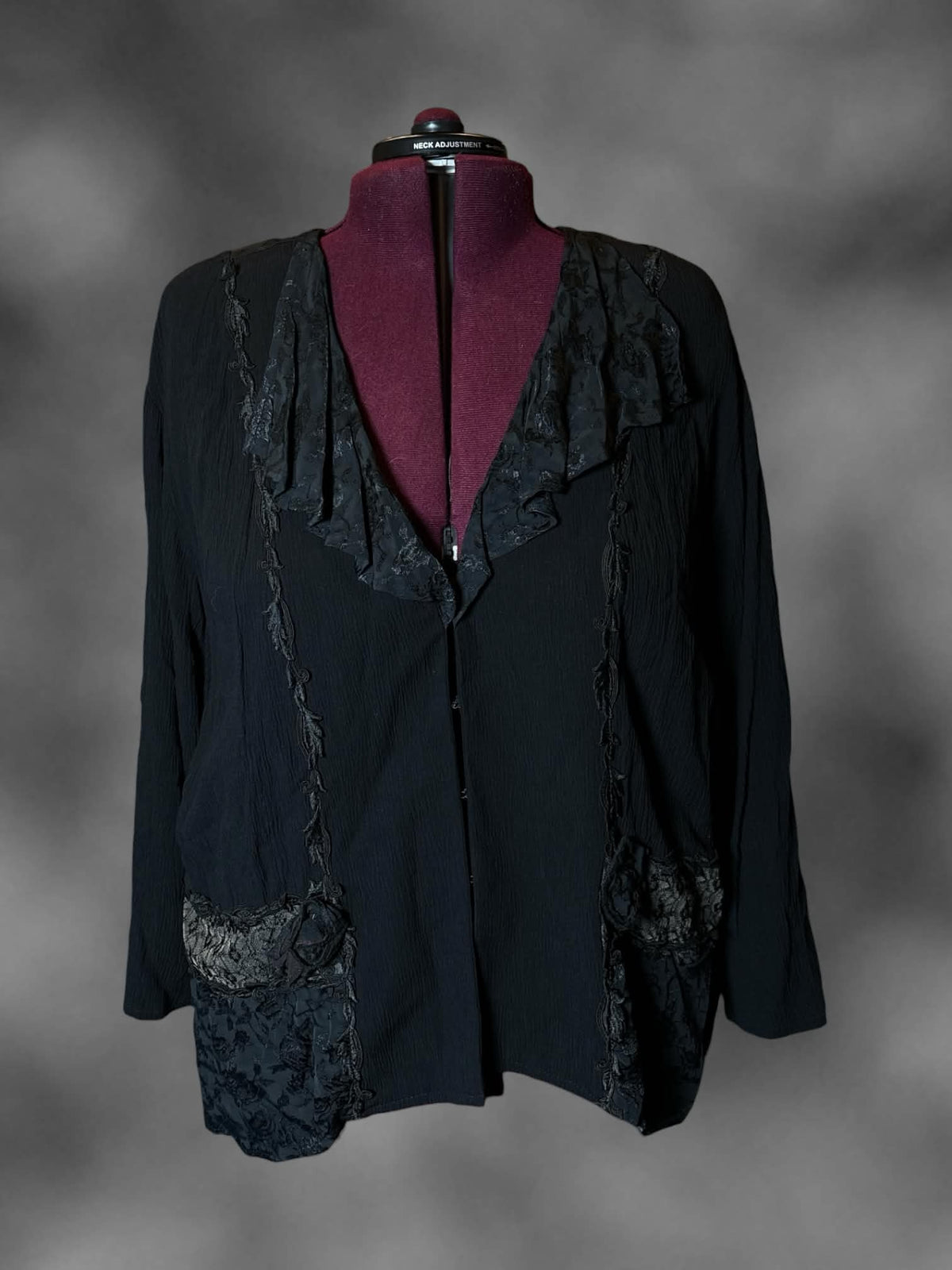 2X vintage black long-sleeve blouse with ruffle lace design, padded shoulders, and clasps and pockets on front