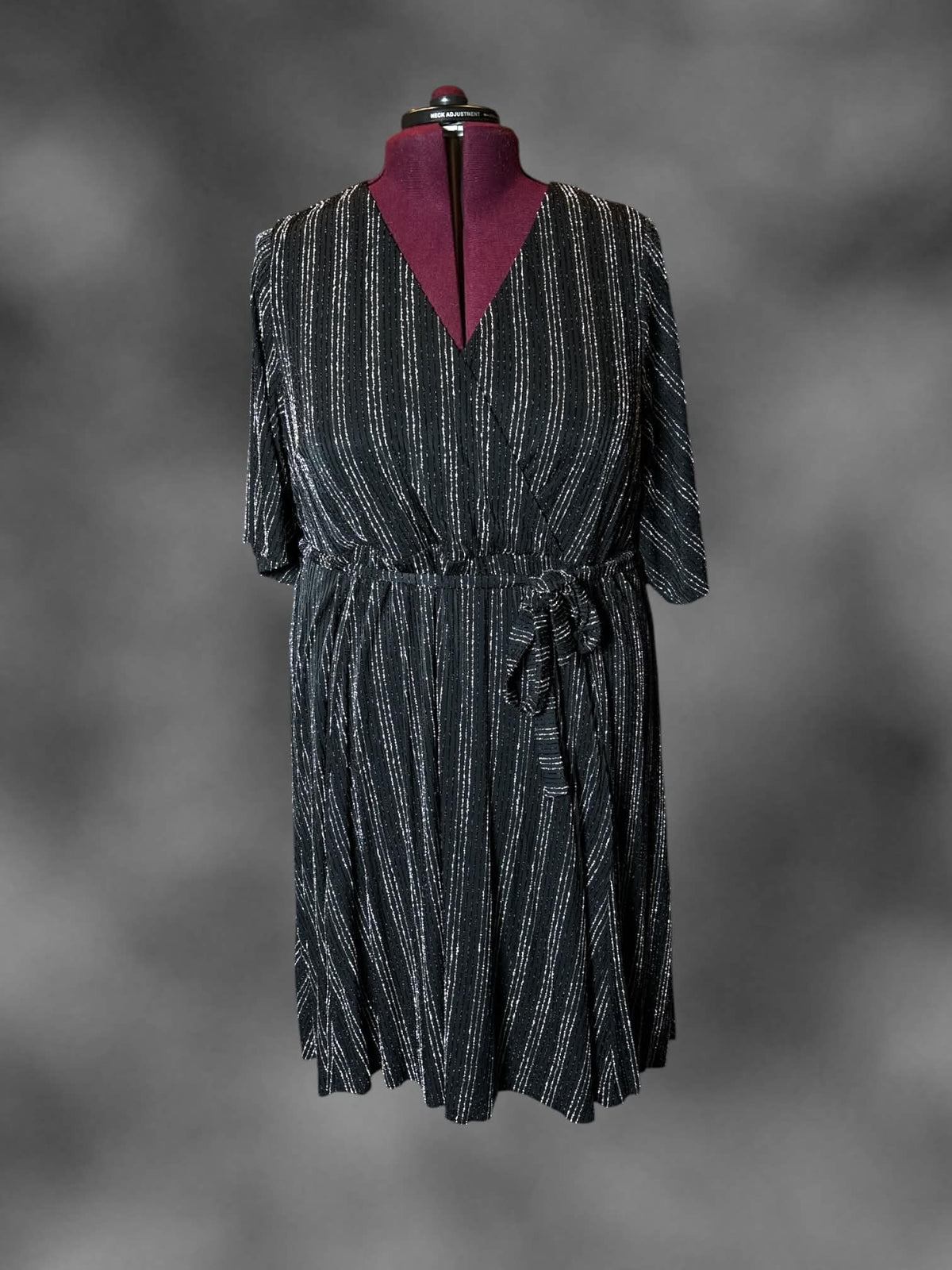 4X Torrid black dress with metallic striped pattern, wrap-around design, and tie around waist