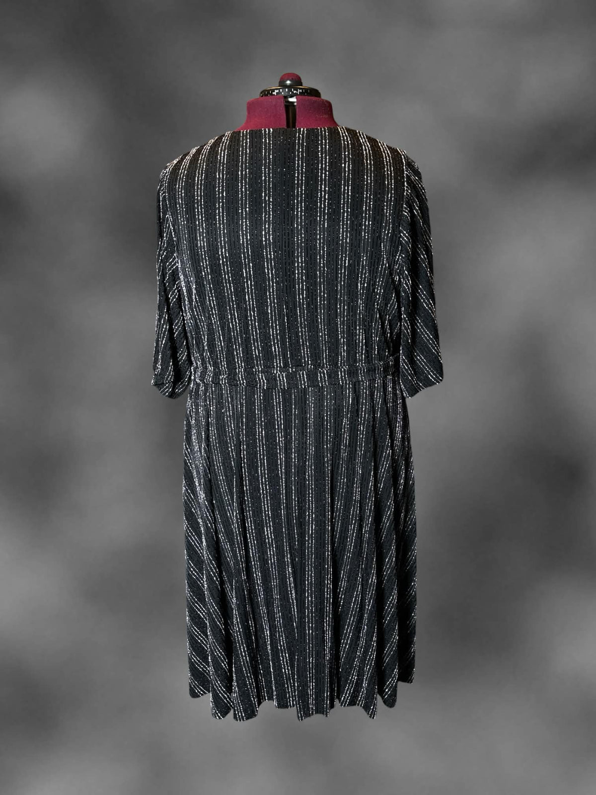 4X Torrid black dress with metallic striped pattern, wrap-around design, and tie around waist