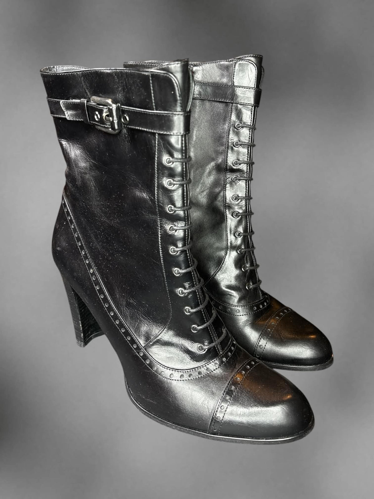 Size 8 Y2K black heal boots with decorative laces on front, and zipper on side