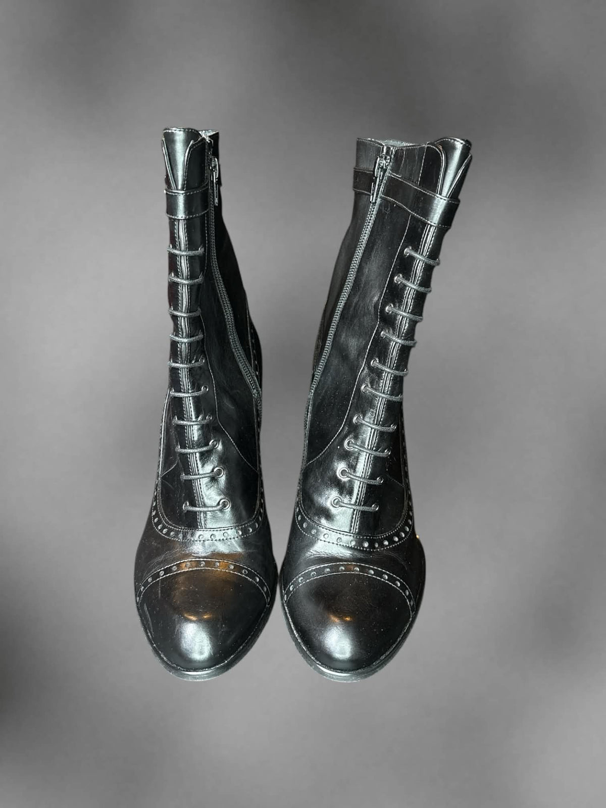 Size 8 Y2K black heal boots with decorative laces on front, and zipper on side