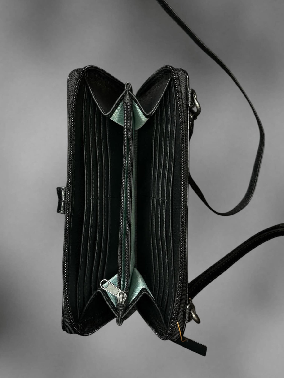 The Sak black faux leather shoulder bag with zipper pockets