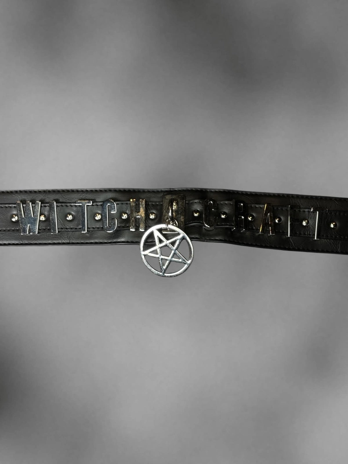 S-L Black stretch waist belt with metallic “Witch Craft” design on front, and buttons on back