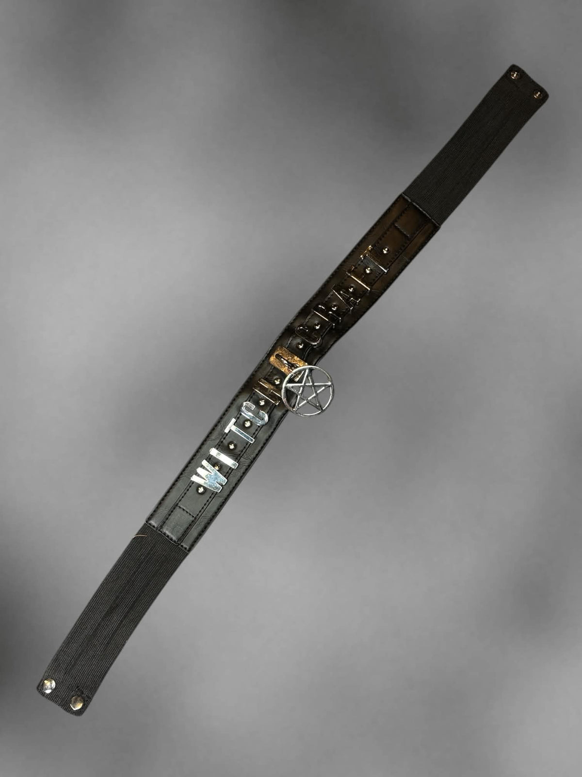 S-L Black stretch waist belt with metallic “Witch Craft” design on front, and buttons on back
