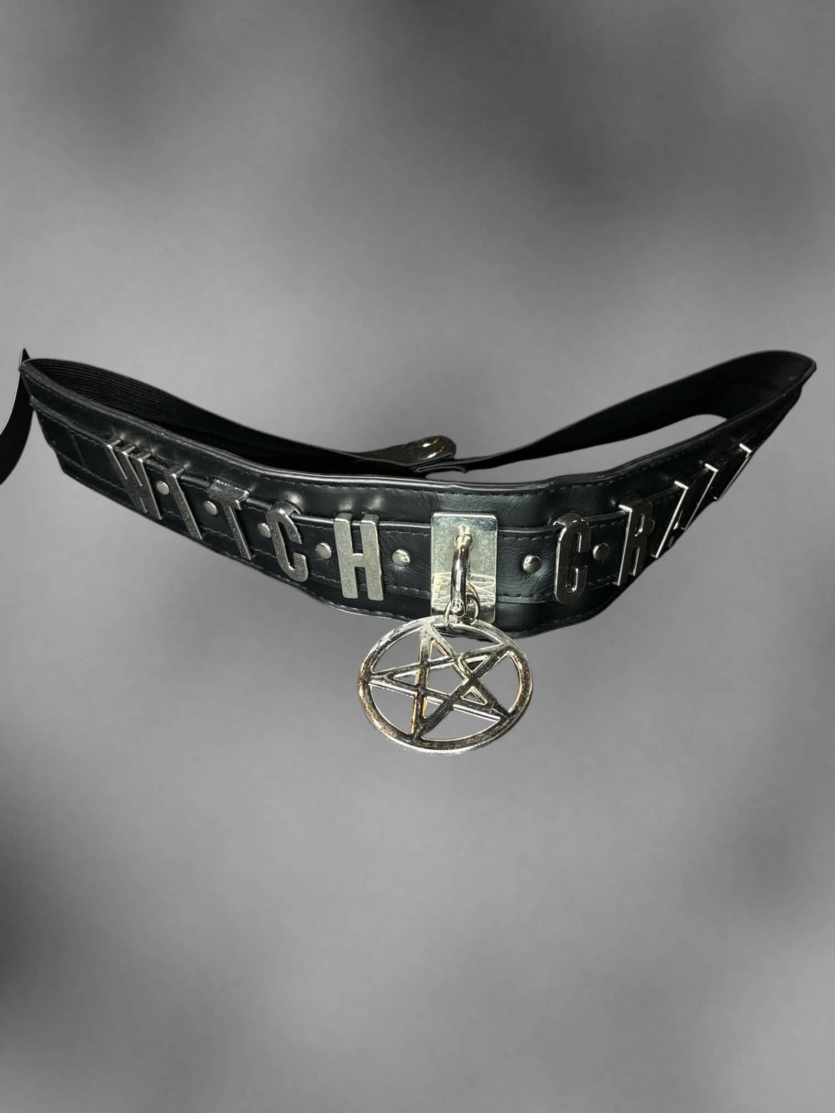 S-L Black stretch waist belt with metallic “Witch Craft” design on front, and buttons on back