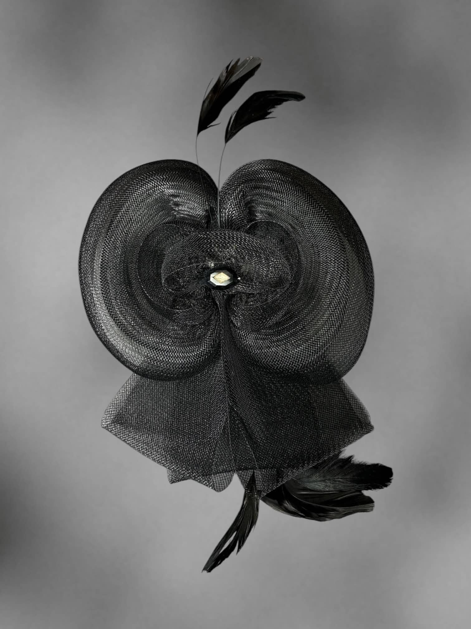 Black mesh bow hair clip with decorative feathers