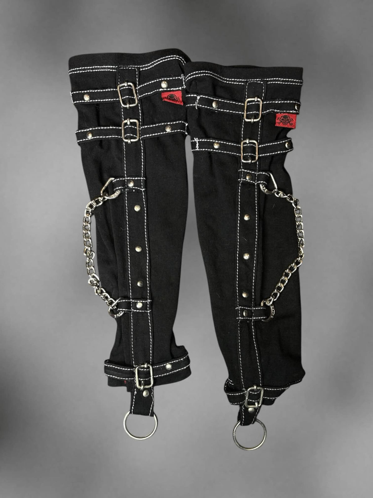 Tripp NYC black arm warmers with chains and middle finger o-ring