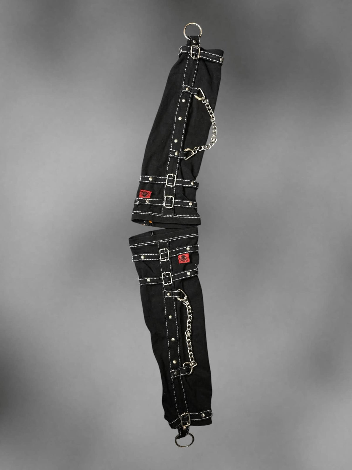 Tripp NYC black arm warmers with chains and middle finger o-ring