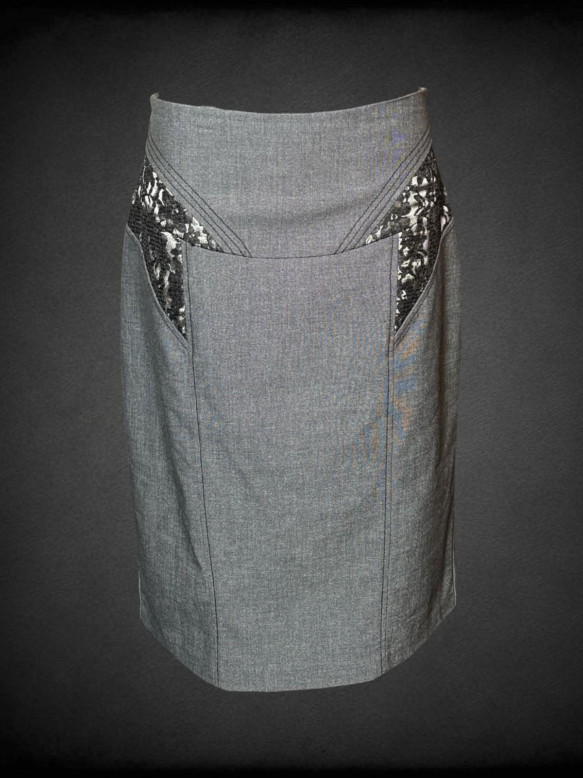 M XOXO grey pencil skirt with black lace design on front, zipper on back, and pleated hemline on back
