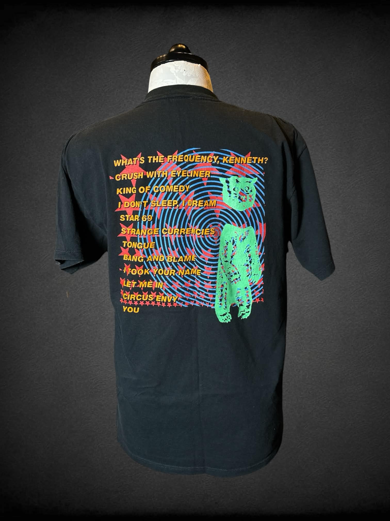 1X Nice Man black t shirt with “R.E.M. Monster” band graphic on front, and song titles graphic on back