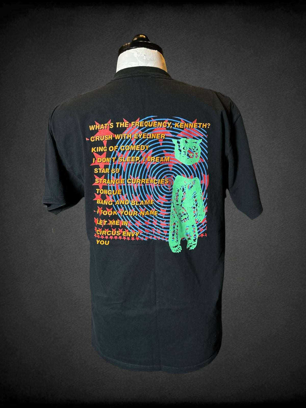 1X Nice Man black t shirt with “R.E.M. Monster” band graphic on front, and song titles graphic on back