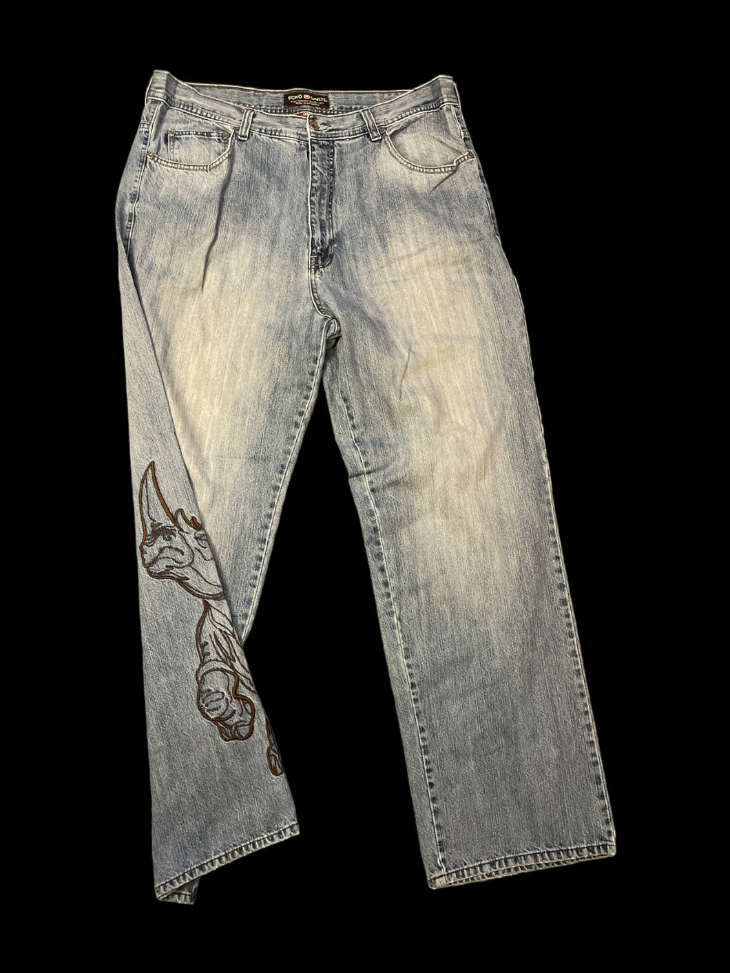 1X Light blue denim jeans w/ large brown embroidered rhinoceros on leg, belt loops, pockets, & button/zipper closure