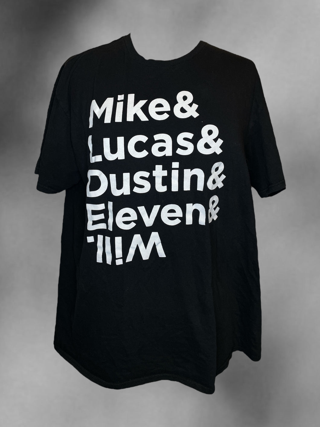 1X Black & white cotton “Stranger Things” short sleeve crew neckline top w/ “Mike & Lucas & Dustin & Eleven & Mike.” text graphic