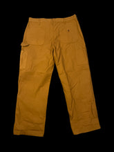 Load image into Gallery viewer, XL Dijon brown Carhartt cotton canvas carpenter pants w/ belt loops, tool pocket/loop, pockets, &amp; button/zipper closure

