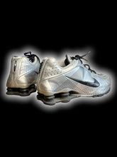 Load image into Gallery viewer, 9 Silver Nike Shox sneakers w/ black geometric line pattern, black swoosh logo, black laces, shock absorber soles, &amp; air hole perferations
