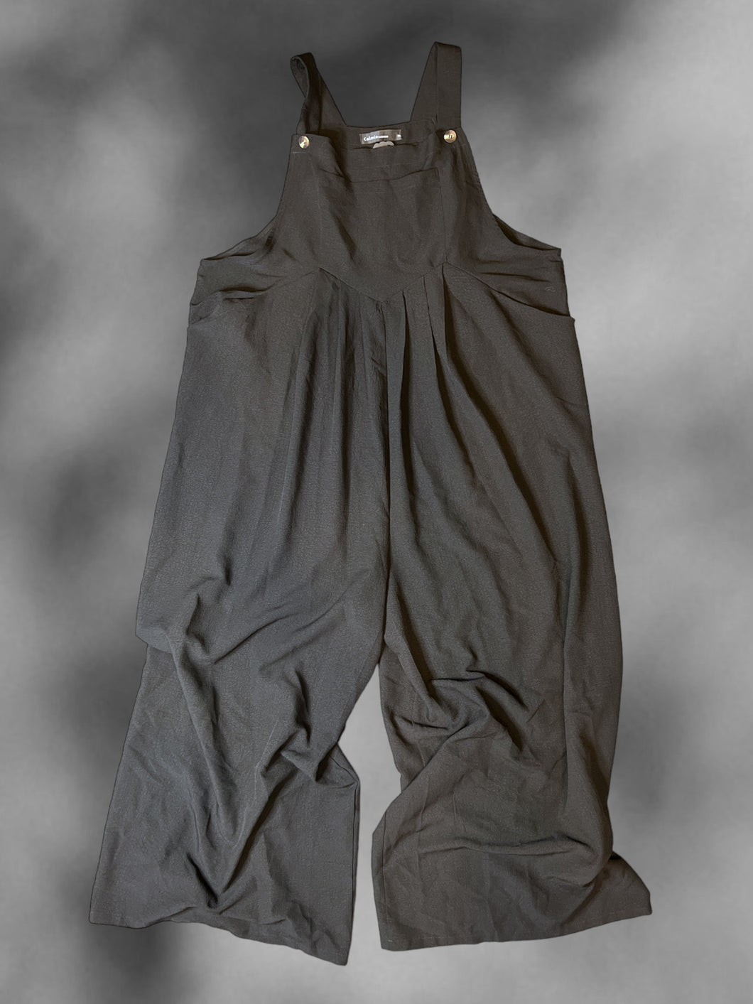 2X Black sleeveless wide leg jumpsuit w/ button adjustable straps, pleating, & pockets