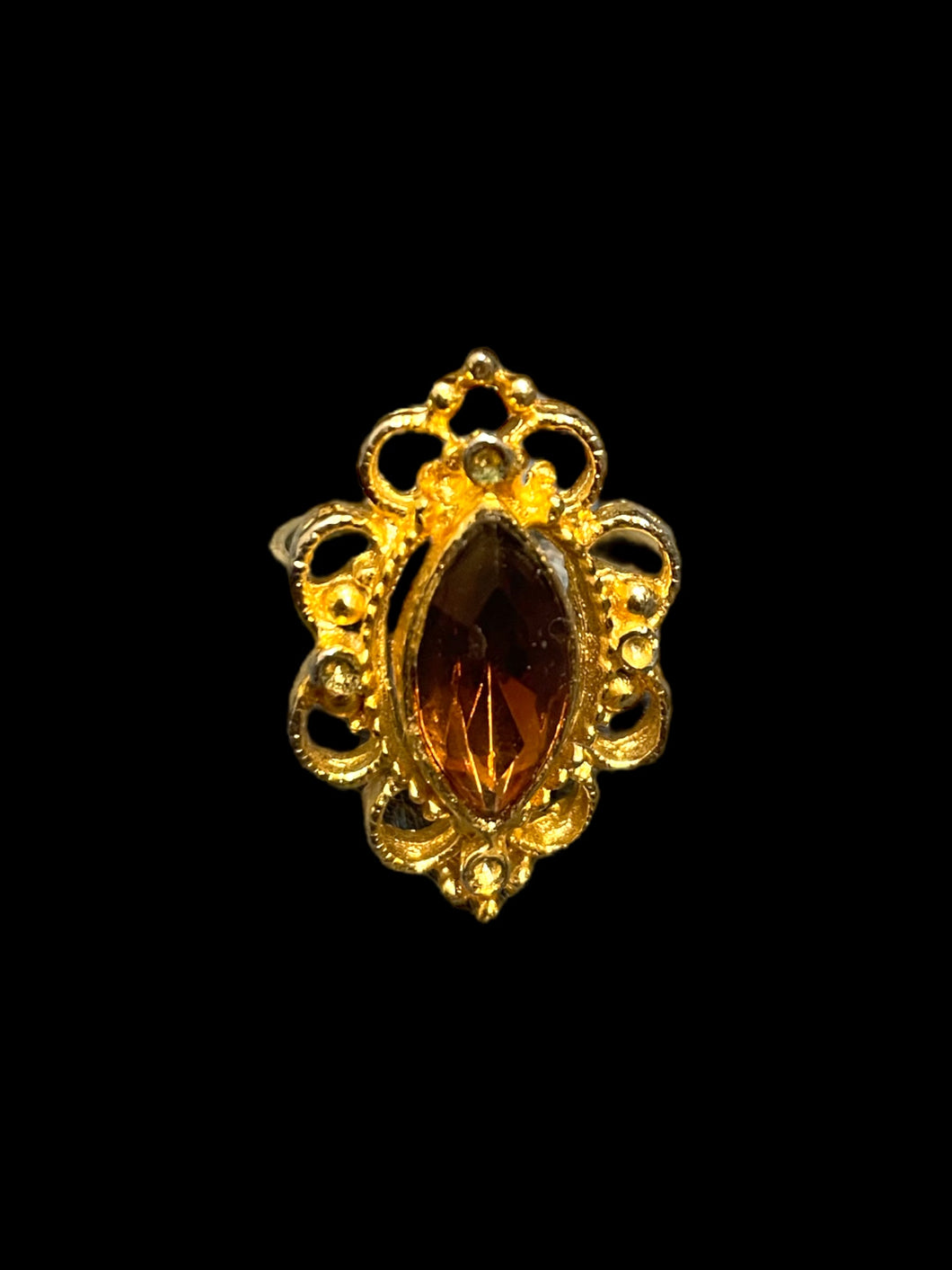 8.5 Gold like ring w/ diamond shaped brown cut gem in elaberate swirled setting