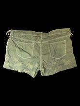 Load image into Gallery viewer, XL Green raw hem shorts w/ faded tree detail, white lace up sides, white stitching, belt loops, pockets, &amp; zipper/button closure
