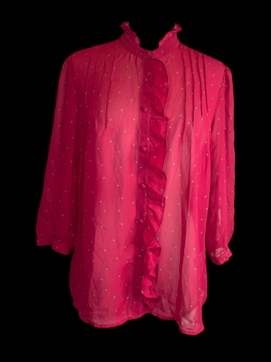 L Hot pink sheer button-up top w/ grey polka dot pattern, ruffle hem detail, pleated bust, & button cuffs