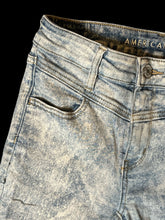 Load image into Gallery viewer, XS Light blue distressed denim pants w/ skinny legs, pockets, &amp; button/zipper closure
