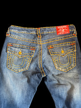 Load image into Gallery viewer, M Blue denim lightly distressed jeans w/ yellow &amp; orange embroidered stitching, jeweled buttons, back flap buttoned pockets, &amp; zipper/button closure
