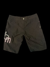 Load image into Gallery viewer, M Black shorts w/ &quot;Volcom&quot; brand embroidered design, velcro pocket, pink stitching detail, &amp; zipper to lace/velcro closure
