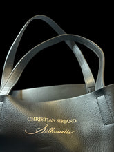 Load image into Gallery viewer, Black pleather tote bag w/ &quot;Christian Siriano Silhouette&quot; gold text
